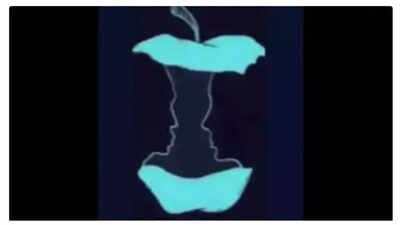 Optical illusion showing either an apple core or two faces