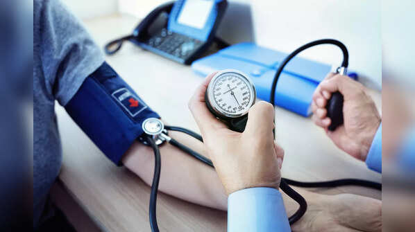 Person having their blood pressure checked by a healthcare professional.